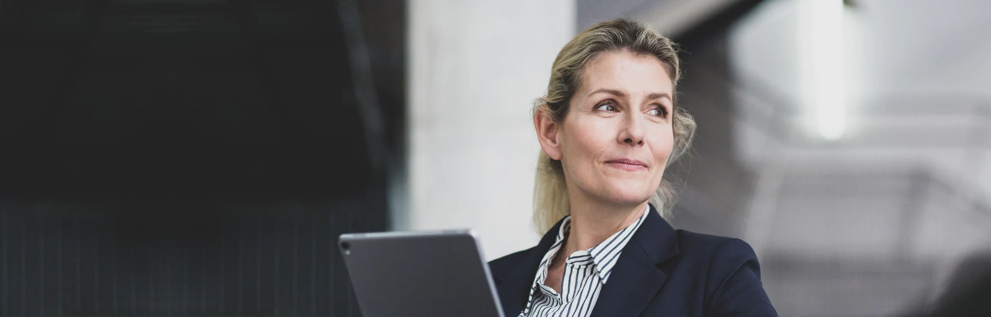 Woman using her tablet to sign on to  CityBC Trust Online SmartBanking for Business
